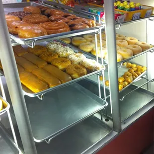 a variety of donuts in a display case
