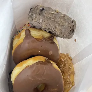 chocolate covered donuts in a paper bag