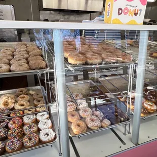a variety of donuts in a display case
