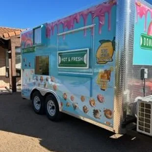 an ice cream truck parked in front of a building