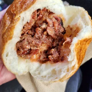 a hand holding a sandwich