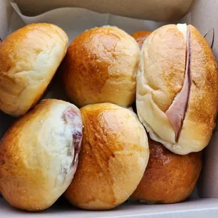 a box of ham and cheese rolls