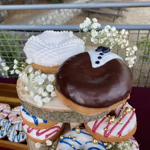 Bride and Groom donuts for a wedding by Donut Town.  We added a little floral decor and it was stunning!