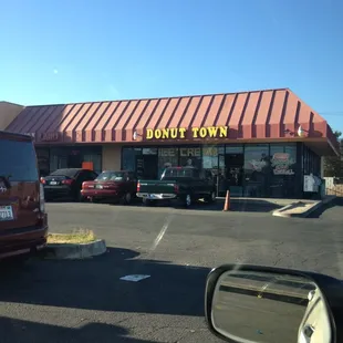 a donut shop in a parking lot