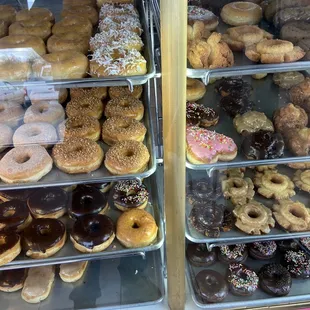 a variety of donuts in a display case