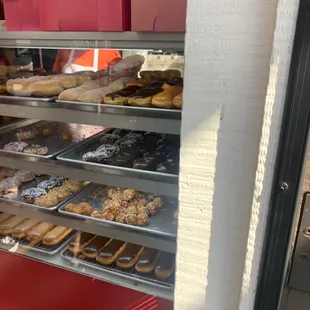a variety of donuts in a display case