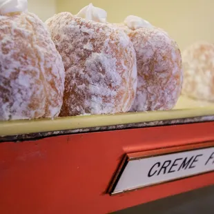 a row of donuts on a shelf