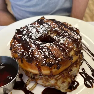 a stack of donuts with chocolate sauce