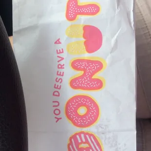 a bag of donuts on a car seat