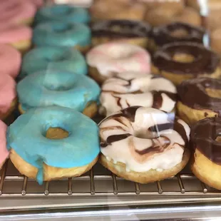 a variety of doughnuts in a display case