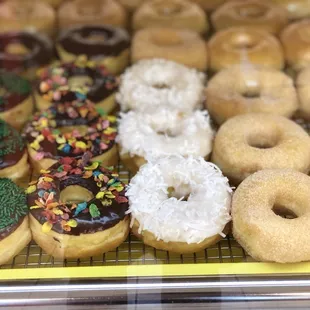 a variety of donuts in a display case