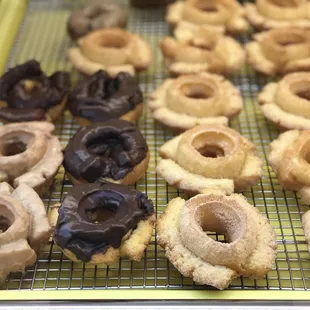 a variety of doughnuts on a cooling rack