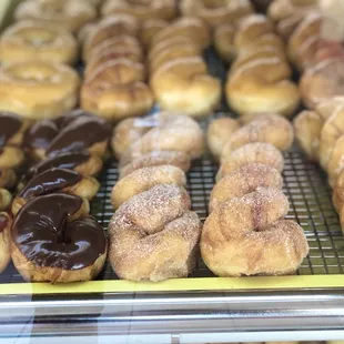 a variety of donuts in a display case
