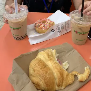 Ham and cheese croissant, iced coffee, pink sprinkle donut, Golden Milk Boba drink!