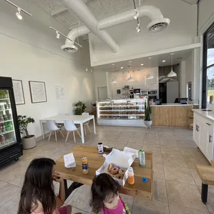 two girls sitting at a table in a coffee shop