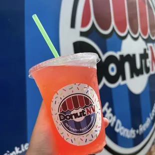 a hand holding a drink
