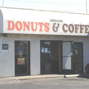 a car parked in front of a donut shop