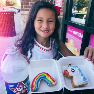 Picture first, honey! She couldn't wait to get her hands on the rainbow  donut, hence the distortion