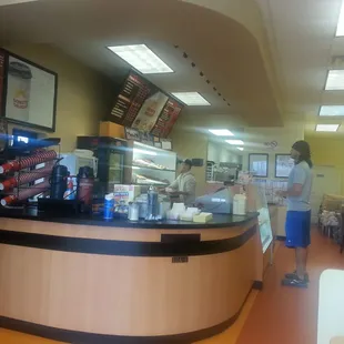 a woman standing in a donut shop