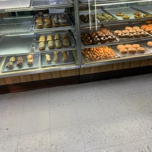 a variety of baked goods in a display case