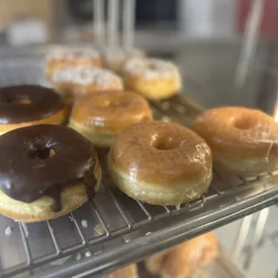 a variety of doughnuts on a cooling rack