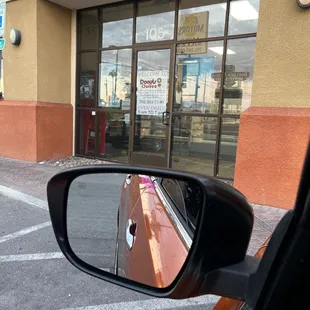 the reflection of a car in a rear view mirror