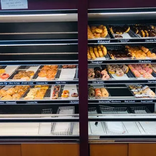 a variety of donuts in a display case