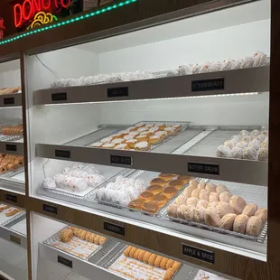 a variety of donuts in a display case