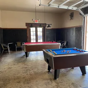 two pool tables in a garage
