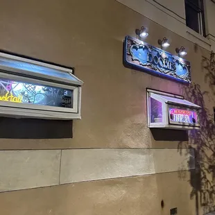 a neon sign on the side of a building