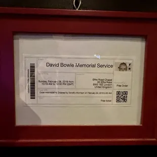 a framed picture of a boarding pass