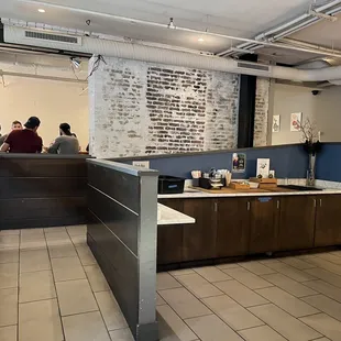 a restaurant with people sitting at the counter