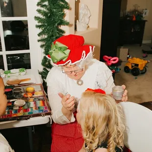 Mrs Claus doing wonderful face painting for our Christmas themed party