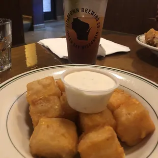 a plate of tater tots and a drink