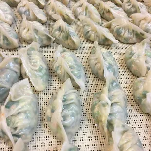 a lot of dumplings being cooked