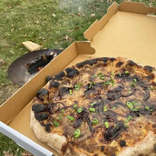 a pizza in a cardboard box