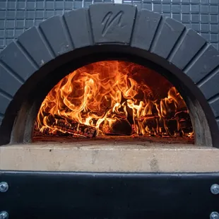 fire coming out of a brick oven