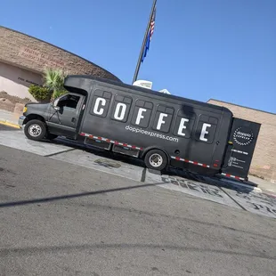 a coffee truck parked in front of a coffee shop