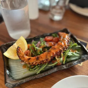 Polpo alla griglia (grilled Mediterranean octopus, wild arugula, cherry tomatoes, red onion, anchovy dressing)