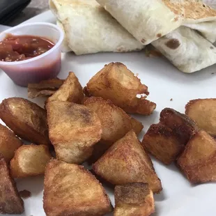 a burrito, potatoes, and a side of ketchup