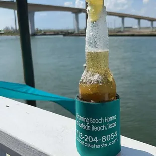 a bottle of beer on a railing