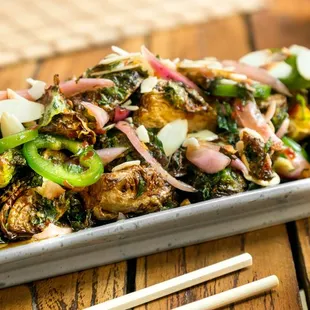 Crispy Brussel Sprouts
Tossed with candied walnuts, chilies, mint, pickled onions, and Spicy Garlic Soy Sauce.