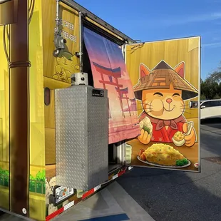 a delivery truck with a cartoon cat on the side