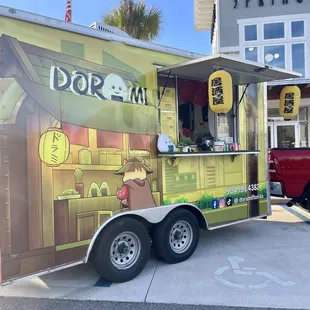 a food truck parked in front of a store