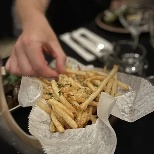 a plate of french fries and a glass of wine