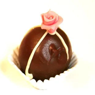 a chocolate truffle with a rose on top