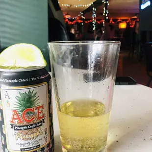 a glass of beer and a can of ace