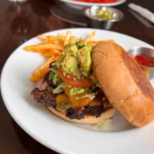 The bacon avo cheddar burger with spicy fries.