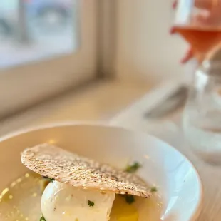 a plate of food and a glass of wine