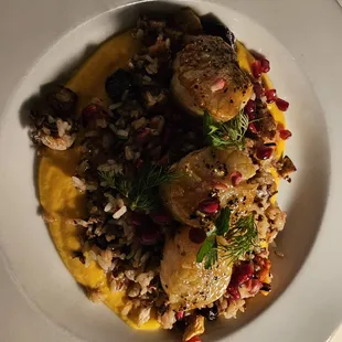 Sea scallops over mashed squash with pomegranate, mango and Mediterranean rice.